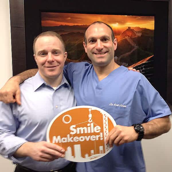 Dr Froum with Patient Holding Smile Makeover Sign