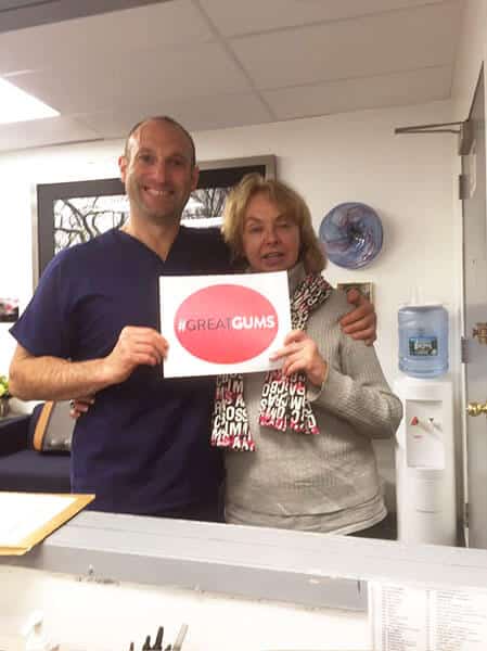Dr Froum Holding Great Gums Sign
